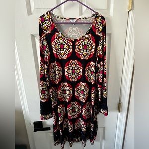 Crown & Ivy Dress. Background of dress is navy blue.